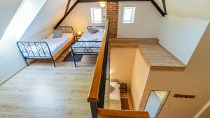 a loft conversion of a house with a bedroom and a bed at Penzion a Restaurace Adria II in Dobrohoř