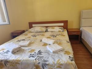 a bedroom with a bed with towels on it at Bosko in Kotor