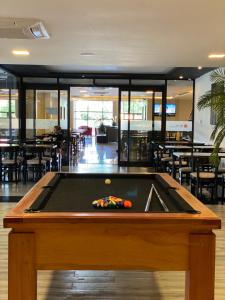 a pool table in the middle of a restaurant at Hotel Sun in Encarnación
