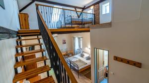 a room with a staircase and a living room at Penzion a Restaurace Adria II in Dobrohoř