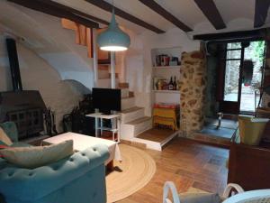 a living room with a couch and a living room with a fireplace at El Bosquet 1897 in Mogente