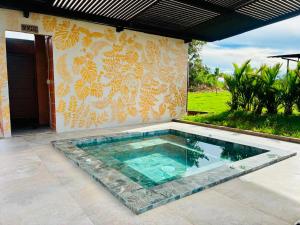 a swimming pool in front of a house at Ecopayara Hotel Puerto Gaitán in Puerto Gaitán