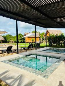 a swimming pool in the middle of a patio at Ecopayara Hotel Puerto Gaitán in Puerto Gaitán