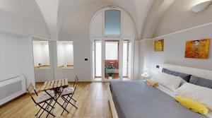 a bedroom with a large bed and a table and chairs at Dante 25 in Triggiano