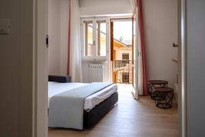 a bedroom with a bed and a door to a balcony at Fuori Squadra in Lanciano