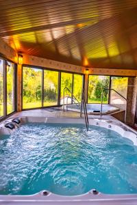 a hot tub in a house with windows at Pousada Vollweiter in Entre Rios