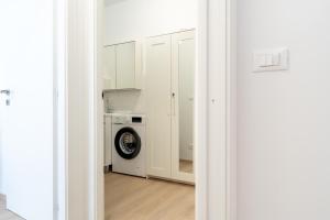 a kitchen with white cabinets and a washing machine at Fuori Squadra in Lanciano