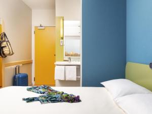 a hotel room with a bed and a sink at ibis budget Warszawa Centrum in Warsaw +70 photos