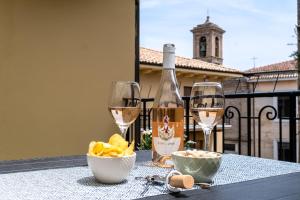 a table with a bottle of wine and two glasses at Fuori Squadra in Lanciano