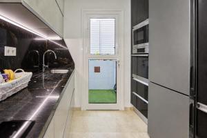 a kitchen with a door leading to a green yard at Villa Gisel in La Playa de Tauro