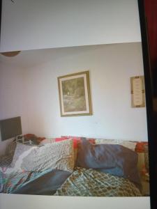 a bedroom with a couch with pillows on it at Rest &Rejoice in Bamboo Market