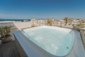 a bath tub sitting on top of a balcony at Albergo Egadi in Favignana