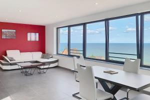 a living room with white furniture and a view of the ocean at AL 4 - Horizon Marin in Ault