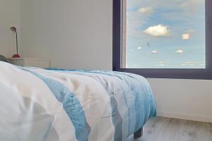 a bedroom with a bed and a large window at AL 4 - Horizon Marin in Ault