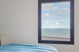 a bedroom with a window with a view of the ocean at AL 4 - Horizon Marin in Ault +38 photos