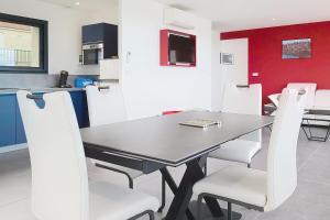 a dining room with a black table and white chairs at AL 4 - Horizon Marin in Ault