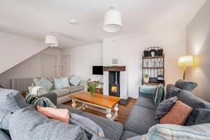 a living room with two couches and a fireplace at Saltwater, East Wittering in East Wittering