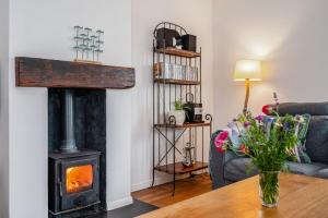 a living room with a wood stove in a room at Saltwater, East Wittering in East Wittering