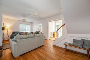 a living room with a couch and a fireplace at Saltwater, East Wittering in East Wittering