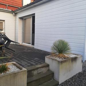 a patio with stairs next to a house at OF08 - Maison entre mer et forêt in Oust-Marais