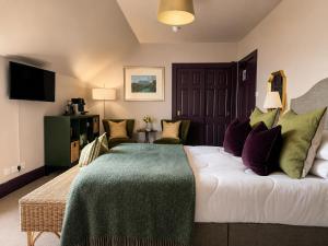 a hotel room with a bed and a television at Ardvreck House in Ullapool