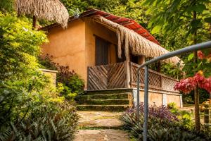 a small house with a porch and stairs to it at Ixak Cabañas in La Pimienta