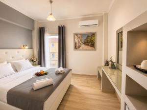 a bedroom with a bed with a tray of fruit on it at San Georgio Hotel in Agios Georgios Pagon