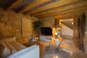 a living room with a couch and a tv at BaguHouse in Pombal