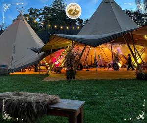 two large tents with a table in the grass at Edinburgh Festival Glamping By Stay Social Stays in Edinburgh