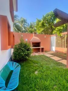 a blue umbrella sitting in the grass next to a house at Isla Lorens in Isla Mujeres +9 photos