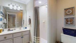 a bathroom with a sink and a shower at Lighthouse Unit B in Jekyll Island +12 photos