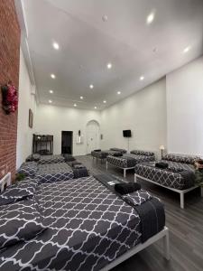 a room with four beds and a brick wall at 31 Street Broadway Hotel in New York
