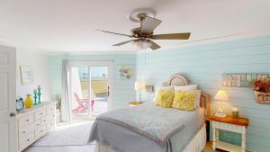 a bedroom with a bed and a ceiling fan at Lighthouse Unit B in Jekyll Island