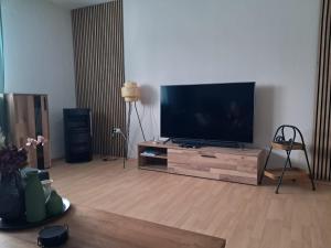 a living room with a large flat screen tv at Ferienwohnung Sankt Michael in Bad Laasphe