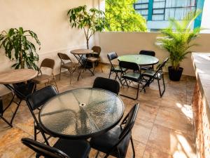 a patio with tables and chairs and plants at Hotel Boutique Venecia Cdmx in Mexico City