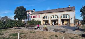 a large building with people walking in front of it at Ranch Borgo Bellavita in Fossalta Maggiore