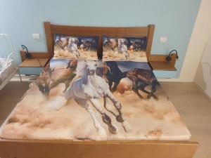 a bed with a painting of a horse on it at Ranch Borgo Bellavita in Fossalta Maggiore