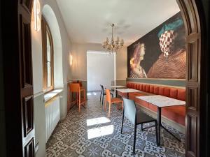 a restaurant with a table and chairs and a painting at La PEPITE in Viareggio