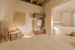 a bedroom with a bed and a chair in a room at Albergo Egadi in Favignana