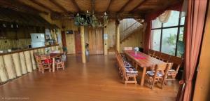 a dining room with a wooden table and chairs at Cabana Magdalena in Câmpulung