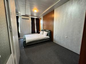 a small bedroom with a bed in a room at Yangi Andijan Hotel in Andijan