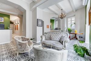 a living room with two chairs and a couch at Best Western Plus Fontana Falconieri Hotel in Messina