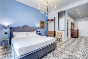 a bedroom with a large white bed and a chair at Best Western Plus Fontana Falconieri Hotel in Messina