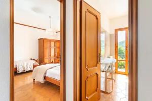 a bedroom with a bed and a large mirror at Casa Yunger in Deiva Marina