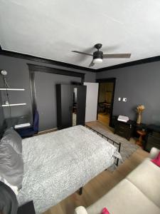 a bedroom with a bed and a ceiling fan at Blue House in Halifax