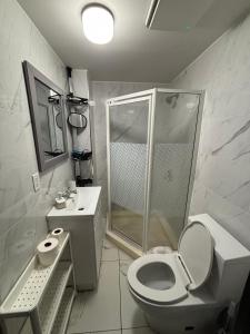 a bathroom with a shower and a toilet and a sink at Blue House in Halifax