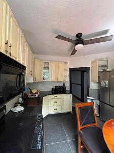 a kitchen with a ceiling fan and a table at Blue House in Halifax