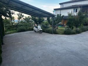 a scooter parked in a parking lot next to a house at Mountain Panorama Garden BBQ ECO in Shumen