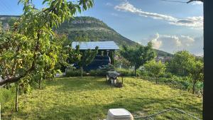 a house in a field with a hill in the background at Mountain Panorama Garden BBQ ECO in Shumen +48 photos