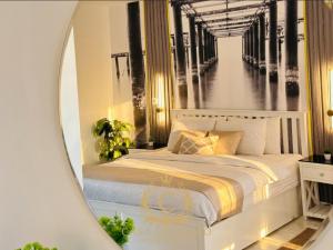 a bedroom with a bed in front of a mirror at Casa Do Cairo - Rehab City in Cairo